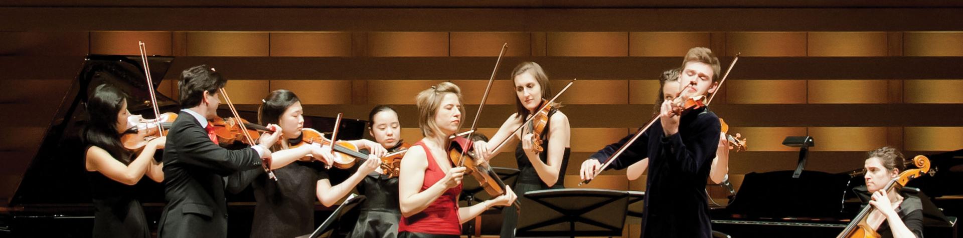 Donate Now - students performing in Koerner Hall