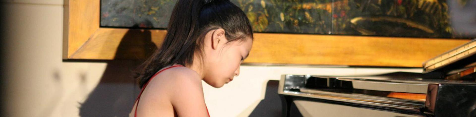 Girl Playing Piano - About the Taylor Academy
